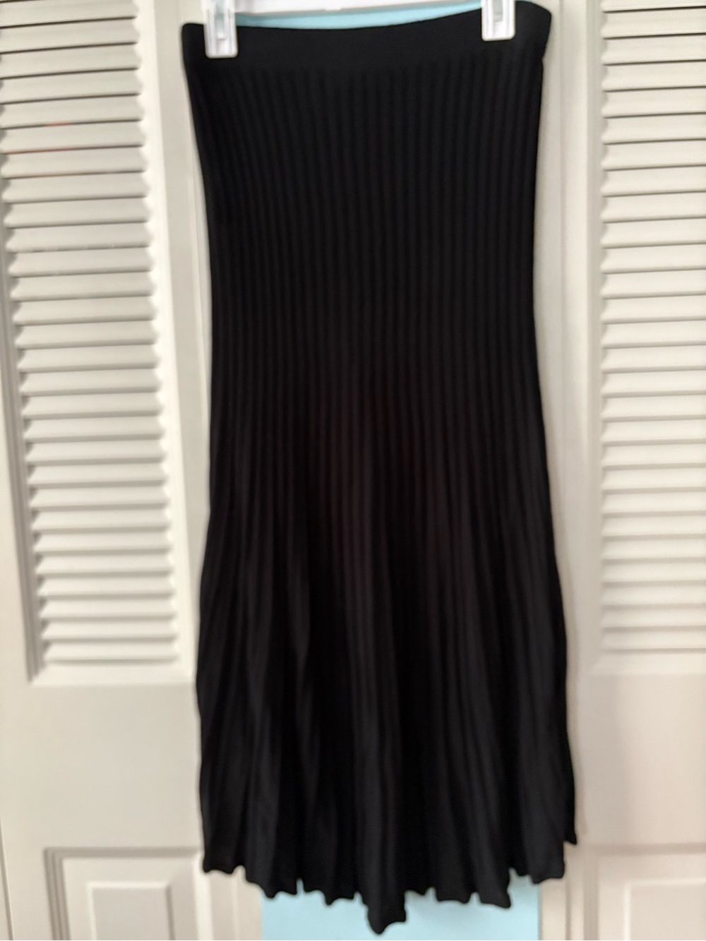 Mini pleat sweater skirt with elastic waist.